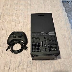 Sleek Black Gaming Console with Controller